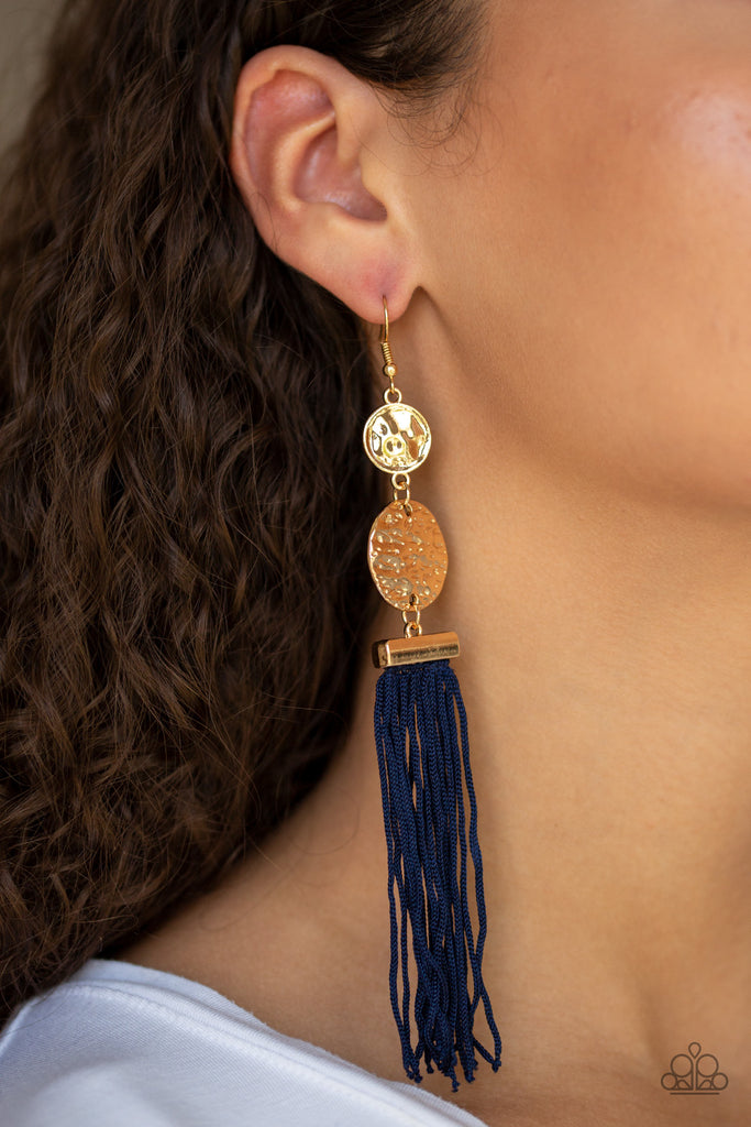 A collection of blue cording streams from the bottom of stacked hammered gold discs, creating a whimsical tassel. Earring attaches to a standard fishhook fitting.  Sold as one pair of earrings.