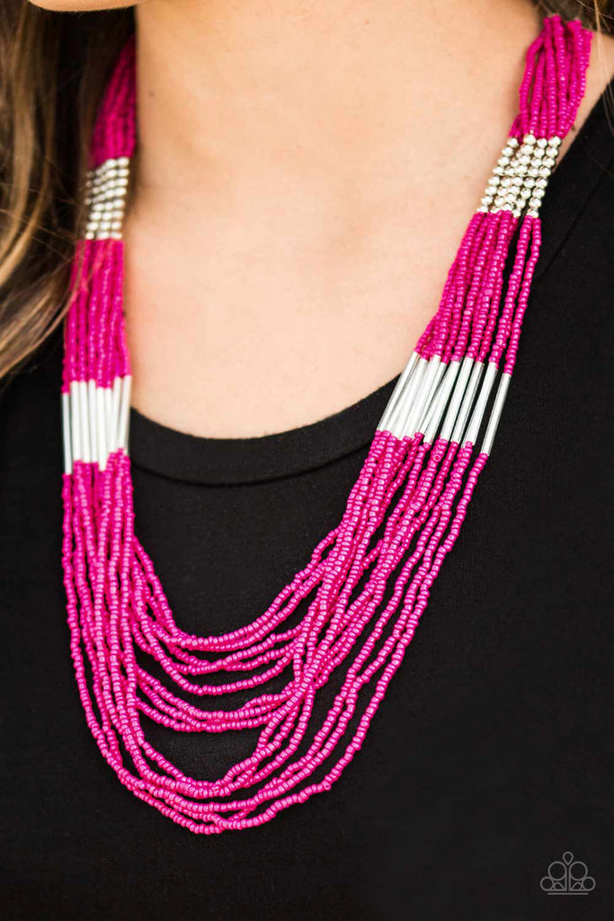 Countless strands of pink seed beads drape across the chest in a layered cascade. Accented with classic silver beading, glassy cylindrical beading is added to the display for a radiant finish. Features an adjustable clasp closure.  Sold as one individual necklace. Includes one pair of matching earrings.