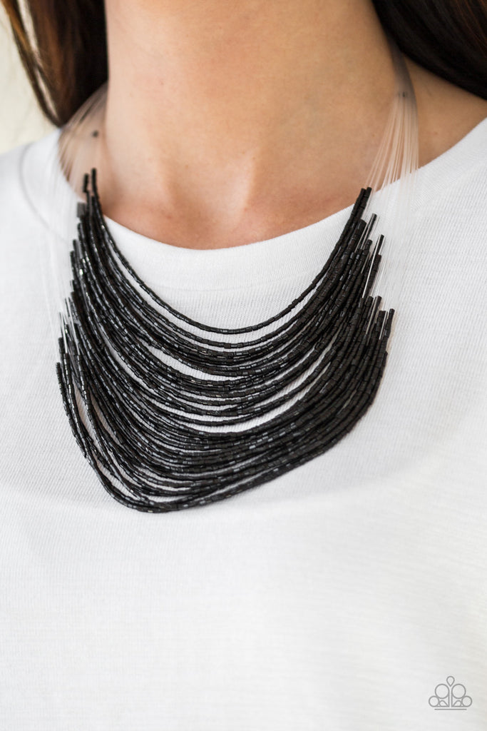 Strand after strand of shimmering black seed beads fall together to create a bold statement piece. Features an adjustable clasp closure.  Sold as one individual necklace. Includes one pair of matching earrings.