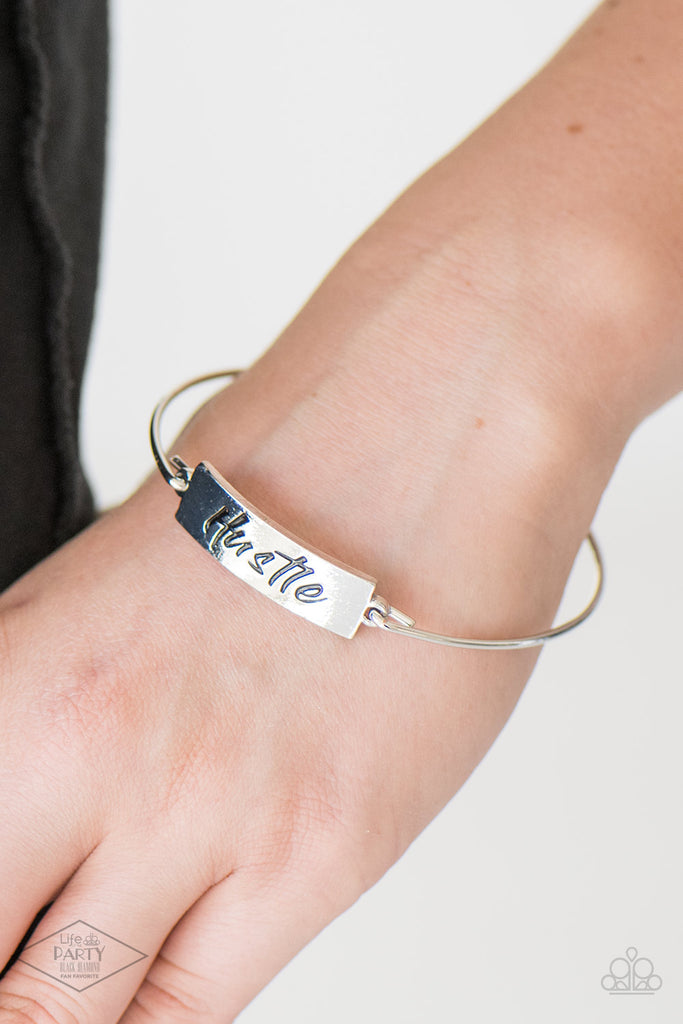Engraved with the inspiring word "Hustle", a shimmery silver plate attaches to a skinny silver bar, creating a dainty bangle.  Sold as one individual bracelet.
