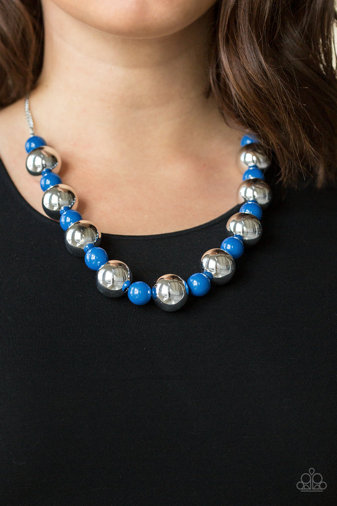 Polished blue beads and dramatic silver beads drape below the collar for a perfect pop of color. Features an adjustable clasp closure.  Sold as one individual necklace. Includes one pair of matching earrings.