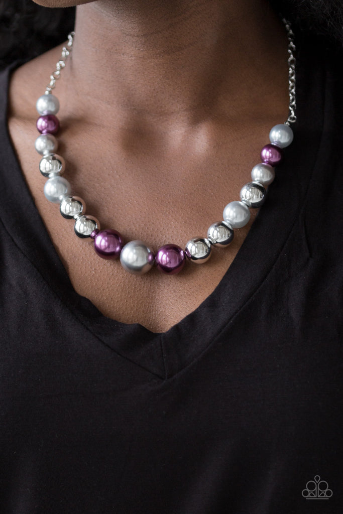 A collection of oversized silver and pearly purple and gray beads drape across the chest for a refined look. Features an adjustable clasp closure.  Sold as one individual necklace. Includes one pair of matching earrings.