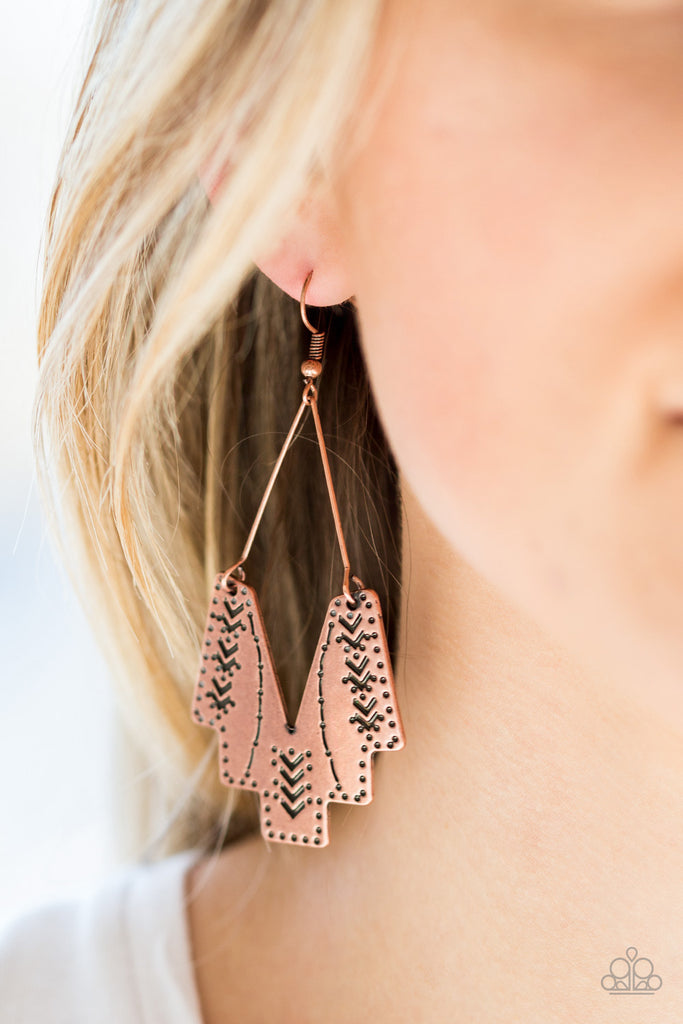 Stamped in tribal inspired patterns, an abstract geometric frame swings from a copper wire fitting for a tribal inspired look. Earrings attaches a standard fishhook fittings.  Sold as one pair of earrings.