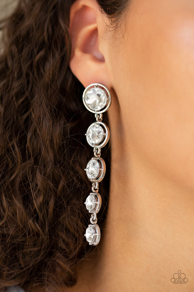 Featuring sleek silver fittings, faceted white gems gradually decrease as they trickle from the ear for a glamorous look. Earring attaches to a standard post fitting.  Sold as one pair of post earrings.