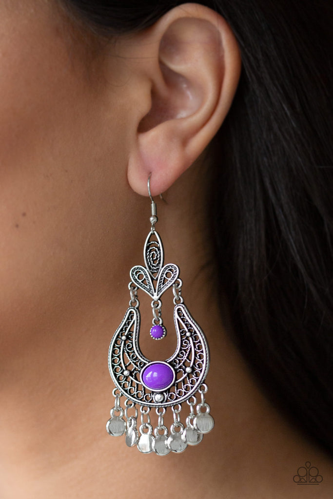 Swirling with vine-like filigree, ornate silver frames delicately link into a stacked frame. Infused with vivacious purple beads, the whimsical frame gives way to a fringe of glistening silver discs for a playful flair. Earring attaches to a standard fishhook fitting.  Sold as one pair of earrings.