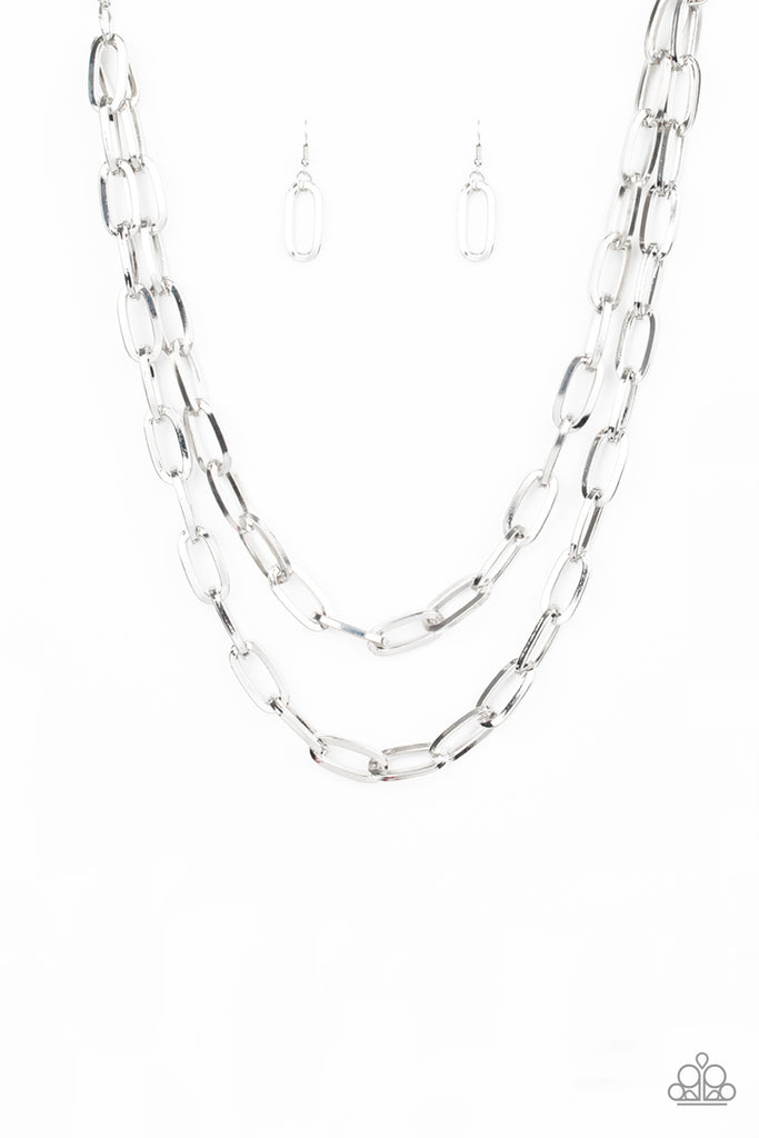 Dramatically oversized silver links connect below the collar, creating two bold layers below the collar for a knockout look. Features an adjustable clasp closure.   Sold as one individual necklace. Includes one pair of matching earrings.