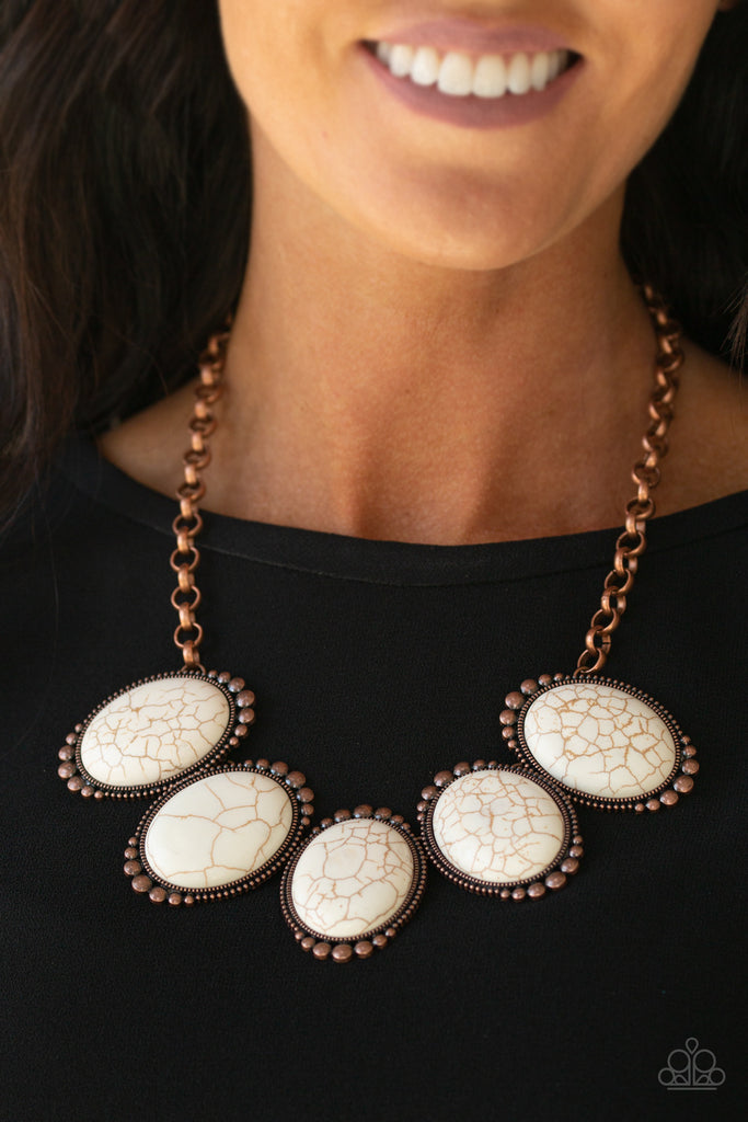 Chiseled into tranquil ovals, oversized white stones are pressed into antiqued copper frames radiating with studded textures. The refreshing frames delicately link below the collar for a statement-making finish. Features an adjustable clasp closure.  Sold as one individual necklace. Includes one pair of matching earrings.