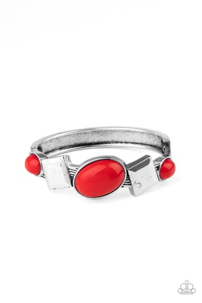 Fiery red oval beads and antiqued silver square frames are pressed into the textured front of a cuff-like bangle, creating a colorful pop of color around the wrist. Features a hinged closure.  Sold as one individual bracelet.