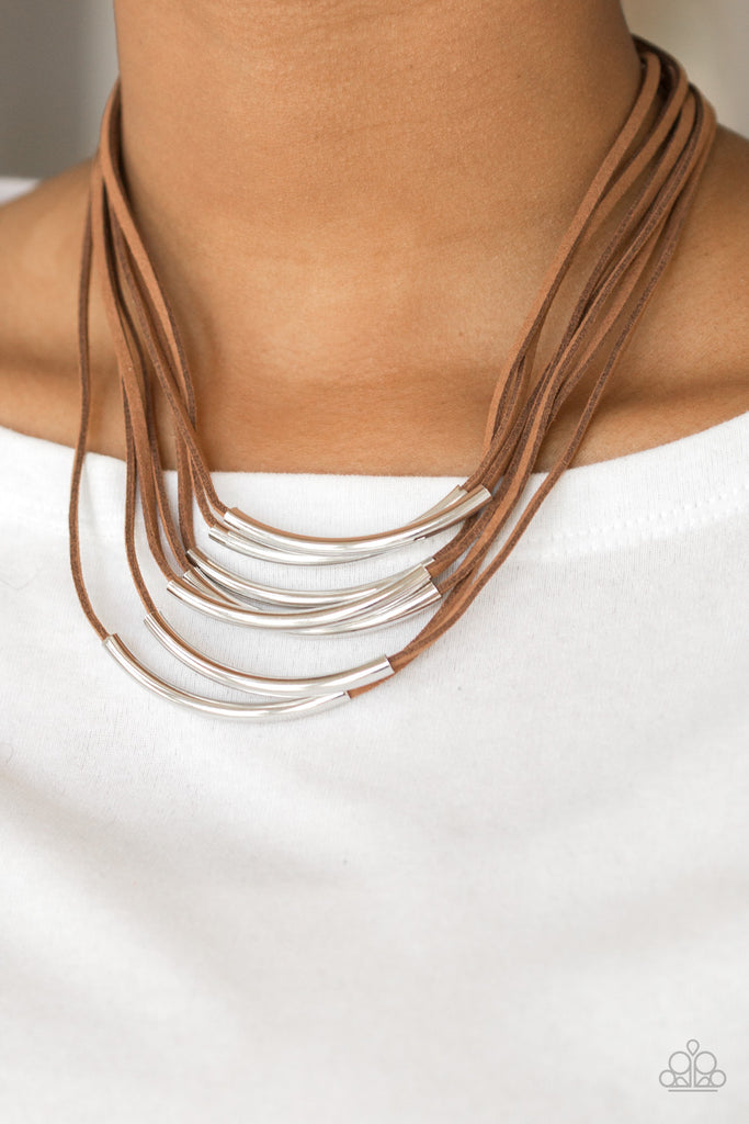 Glistening silver rods slide along strips of brown suede, creating earthy layers below the collar. Features an adjustable clasp closure.  Sold as one individual necklace. Includes one pair of matching earrings.