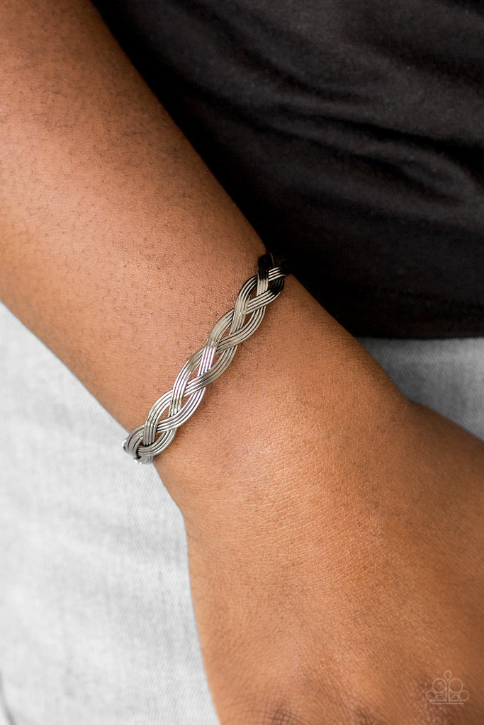 Glistening gunmetal wires braid across the wrist, coalescing into a dainty cuff.  Sold as one individual bracelet.  