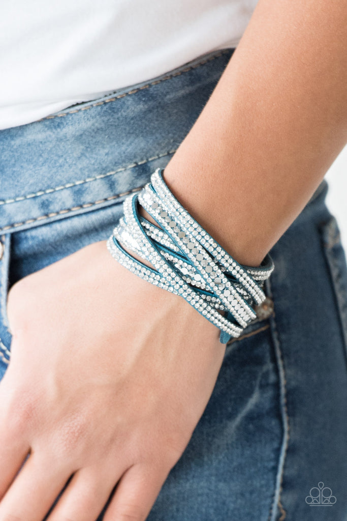 Encrusted in rows of glassy white rhinestones and flat silver studs, three strands of blue suede wrap around the wrist for a sassy look. The elongated band allows for a trendy double wrap around the wrist. Features an adjustable snap closure.  Sold as one individual bracelet.  