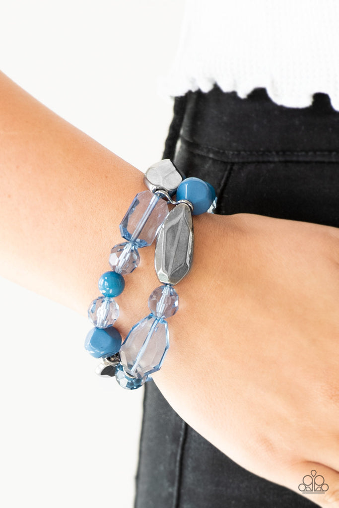 Mismatched gunmetal, polished blue, and crystal-like beads are threaded along interlocking stretchy bands for a whimsical look.  Sold as one individual bracelet.  