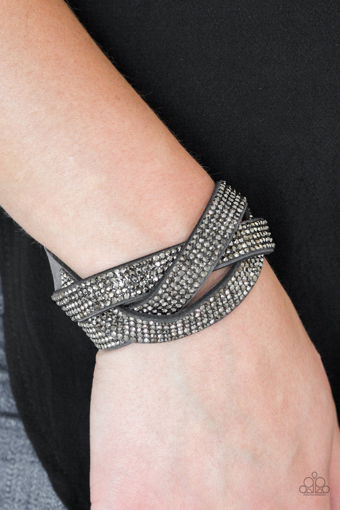 Encrusted in row after row of glittery hematite rhinestones, three gray suede bands braid across the wrist for a sassy look. Features an adjustable snap closure.  Sold as one individual bracelet.