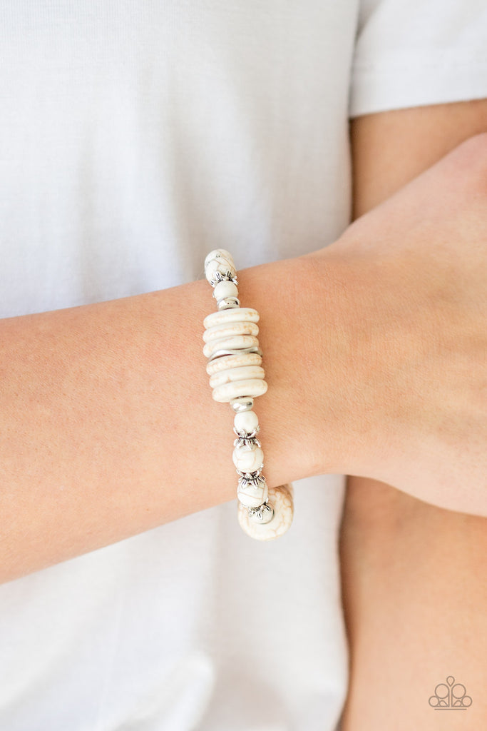 Featuring glistening silver accents, refreshing disc-shaped and round white stone beads are threaded along a stretchy band for a seasonal look.  Sold as one individual bracelet.  