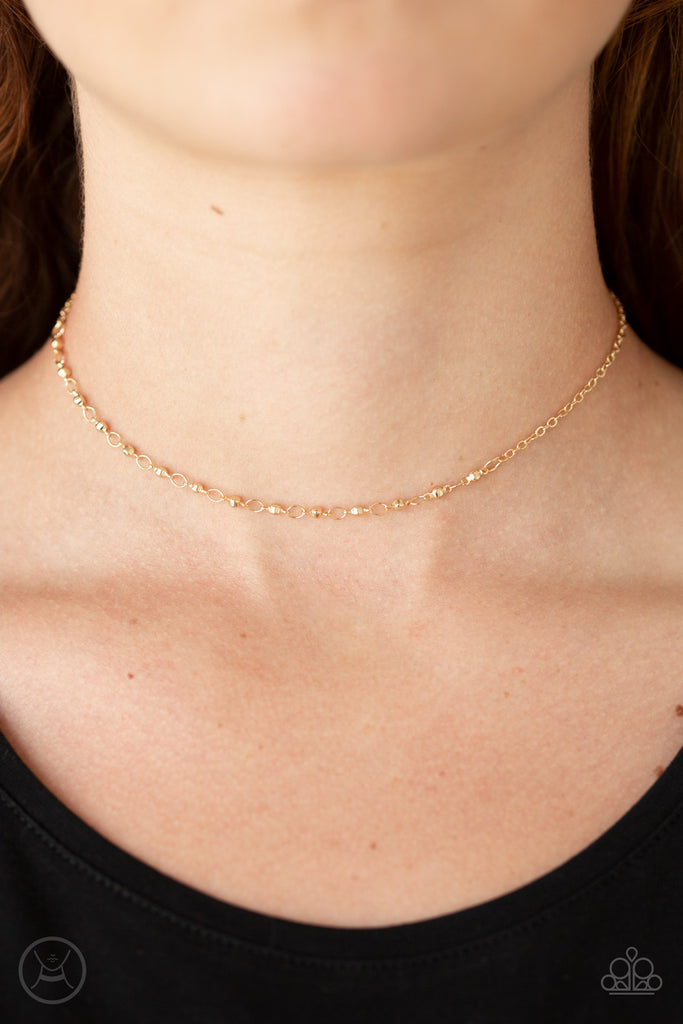 A row of dainty gold satellite chain wraps around the neck for an edgy look. Features an adjustable clasp closure.  Sold as one individual choker necklace. Includes one pair of matching earrings.  