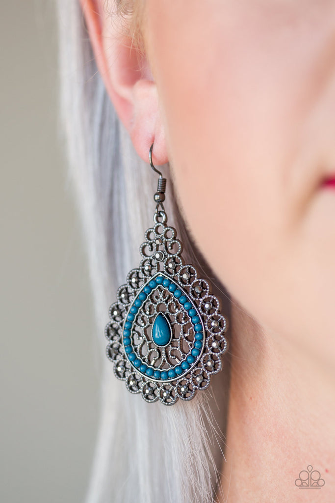 Regal gunmetal filigree climbs a teardrop shaped frame, coalescing into a glistening frame. Dainty blue beads adorn the center of the frame, while glittery hematite rhinestones embellish the outer frame for a refined finish. Earring attaches to a standard fishhook fitting.  Sold as one pair of earrings.