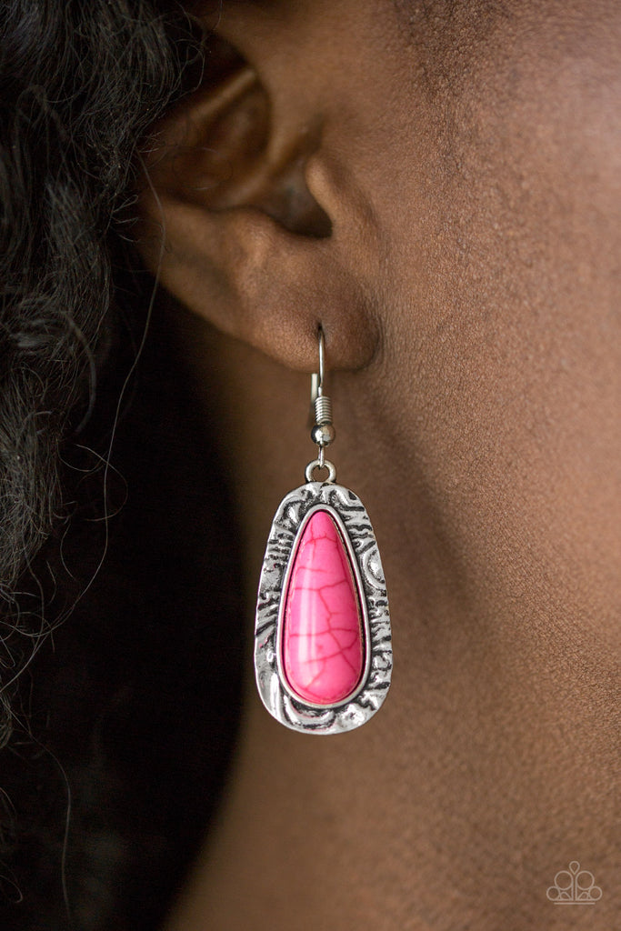 Chiseled into a tranquil teardrop, a vivacious pink stone is pressed into the center of a shimmery silver frame radiating with hammered details for an artisan inspired look. Earring attaches to a standard fishhook fitting.  Sold as one pair of earrings.  