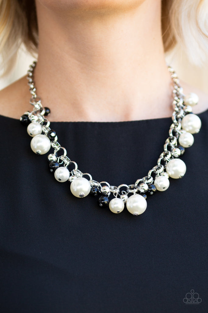 Varying in size, bubbly white pearls, classic silver beads, and shiny black beads swing from the bottom of a glistening silver chain, creating a refined fringe below the collar. Features an adjustable clasp closure.  Sold as one individual necklace. Includes one pair of matching earrings.  