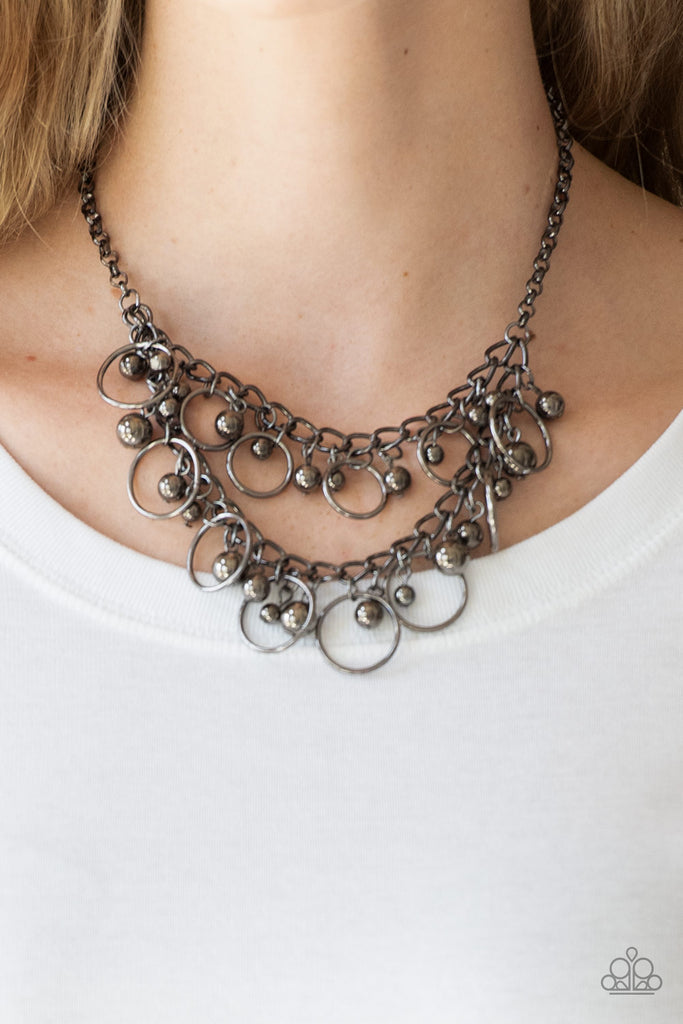 Brushed in a high-sheen finish, mismatched gunmetal beads and airy gunmetal hoops swing from two rows of gunmetal chains, creating an edgy fringe below the collar. Features an adjustable clasp closure.  Sold as one individual necklace. Includes one pair of matching earrings.