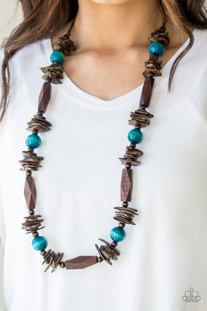 Featuring round, faceted, and distressed finishes, mismatched brown wooden beads are threaded along shiny brown cording. Refreshing blue wooden beads trickle between the earthy accents, adding a colorful finish to the summery palette. Features an adjustable sliding knot closure.  Sold as one individual necklace. Includes one pair of matching earrings.  