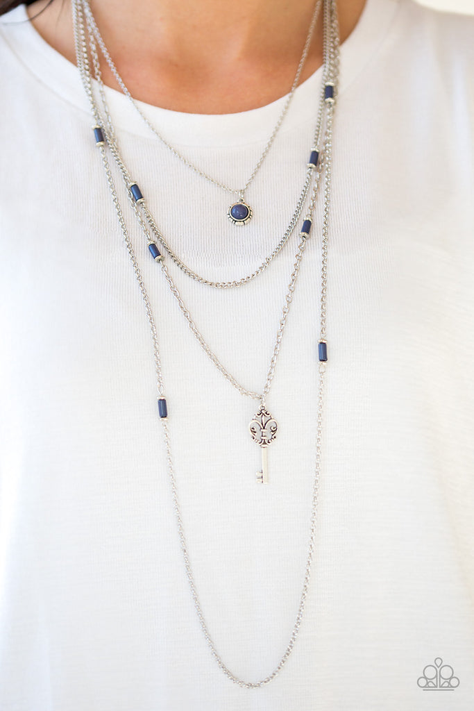Featuring shiny blue and dainty silver accents, a blue beaded pendant gives way to a shimmery silver key for a whimsically layered look. Features an adjustable clasp closure.  Sold as one individual necklace. Includes one pair of matching earrings.