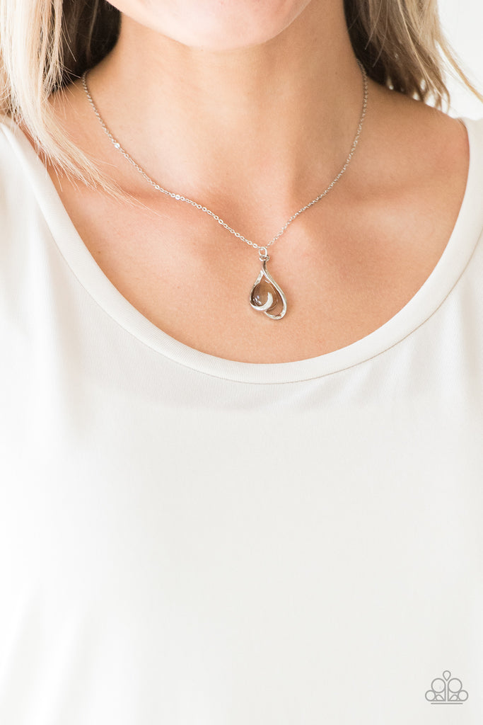 Shimmery silver bars curl around a brown teardrop moonstone, creating an elegant heart shaped pendant below the collar. Features an adjustable clasp closure.  Sold as one individual necklace. Includes one pair of matching earrings.  
