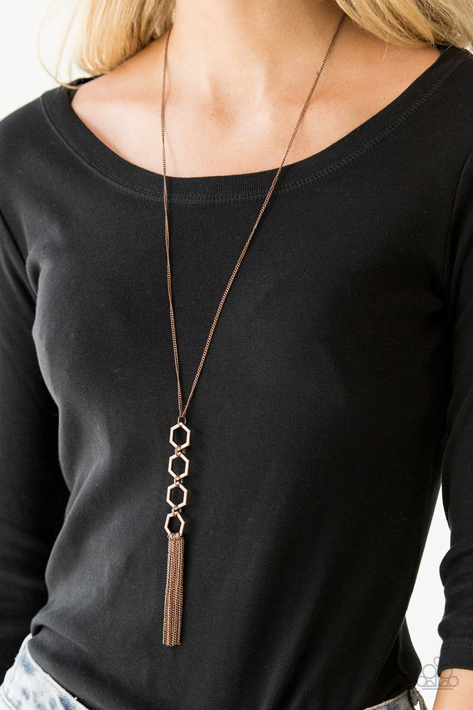Four copper hexagon frames connect at the bottom of a lengthened copper chain, creating an edgy stacked pendant. A glistening copper tassel swings from the bottom of the geometric pendant, adding movement to the modern piece. Features an adjustable clasp closure.  Sold as one individual necklace. Includes one pair of matching earrings.