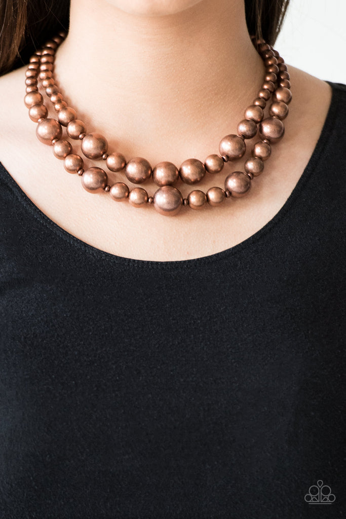 Gradually increasing in size near the center, strands of antiqued copper beads are threaded along invisible wires below the collar for a daring look. Features an adjustable clasp closure.  Sold as one individual necklace. Includes one pair of matching earrings.
