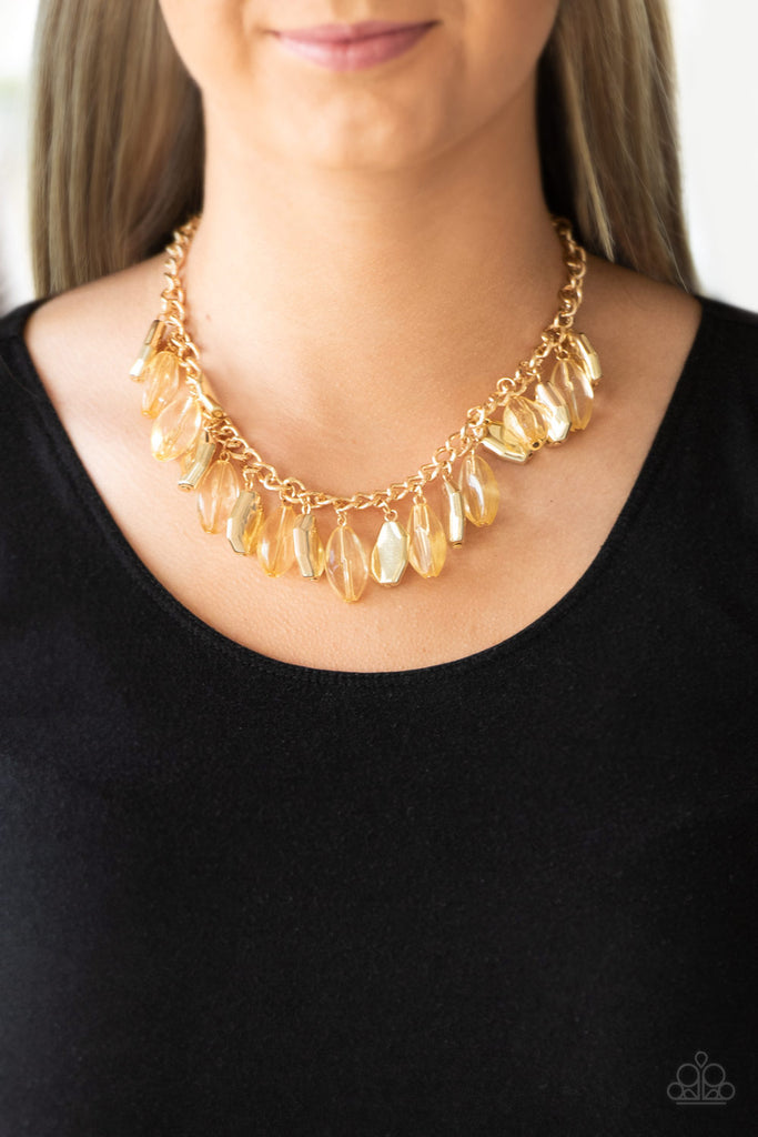 Faceted golden beads and imperfect gold teardrops drip from the bottom of a shimmery gold chain, creating a sassy fringe below the collar. Features an adjustable clasp closure.  Sold as one individual necklace. Includes one pair of matching earrings.  