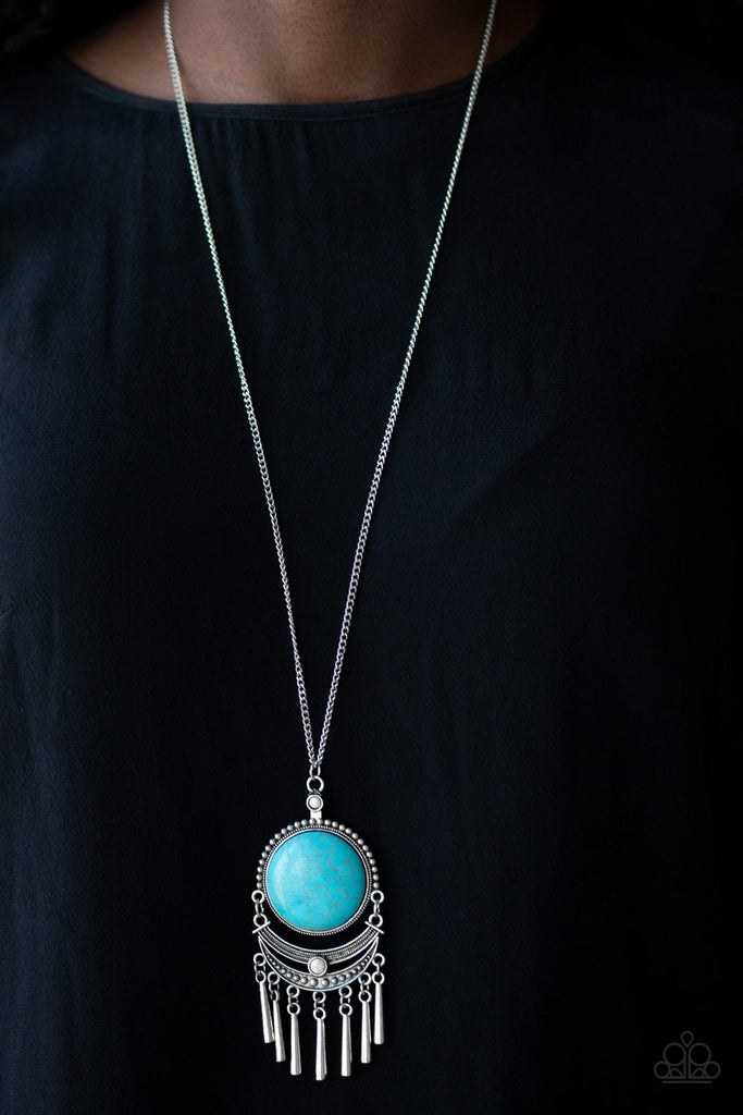Swinging from the bottom of a lengthened silver chain, a dramatic turquoise stone gives way to an ornate crescent shaped frame dotted with a dainty white stone. Brushed in an antiqued shimmer, flared silver bars swing from the bottom of the dramatic pendant, adding a playful movement to the seasonal palette. Features an adjustable clasp closure.  Sold as one individual necklace. Includes one pair of matching earrings.