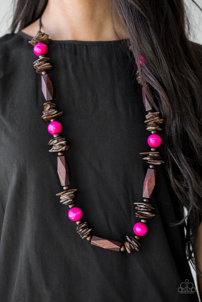 Featuring round, faceted, and distressed finishes, mismatched brown wooden beads are threaded along shiny brown cording. Vivacious pink wooden beads trickle between the earthy accents, adding a colorful finish to the summery palette. Features an adjustable sliding knot closure.  Sold as one individual necklace. Includes one pair of matching earrings.  