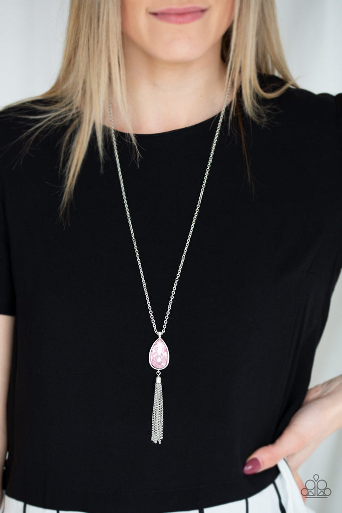 A pink teardrop gem swings from the bottom of a lengthened silver chain for a dramatic look. A shimmery silver chain tassel swings from the bottom of the pendant for a glamorous finish. Features an adjustable clasp closure.  Sold as one individual necklace. Includes one pair of matching earrings.