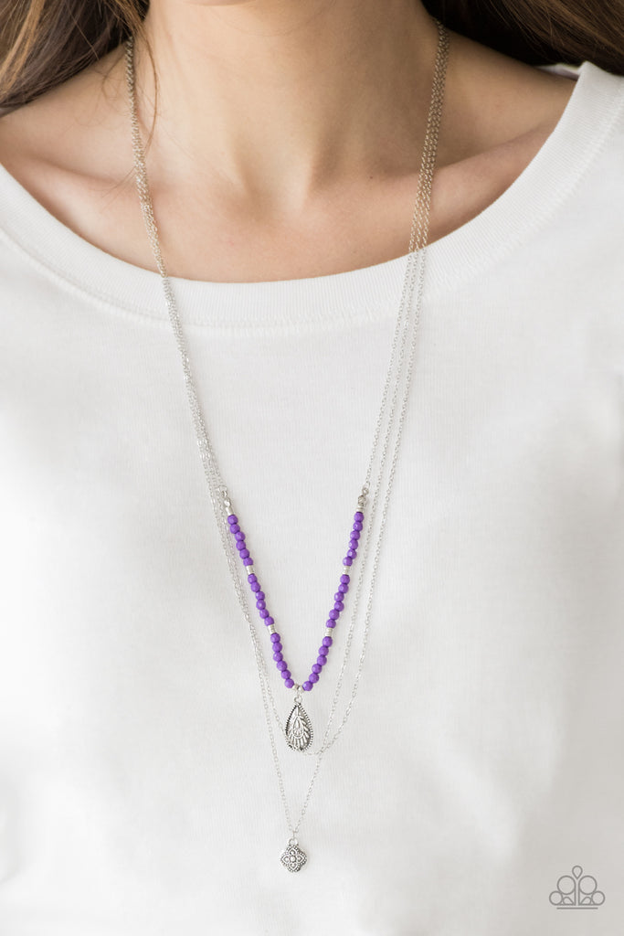 Infused with vivacious purple beading and an ornate silver teardrop pendant, a colorfully beaded strand gives way to a plain silver chain and a dainty silver chain featuring an antiqued pendant for a whimsically layered look. Features an adjustable clasp closure.  Sold as one individual necklace. Includes one pair of matching earrings.