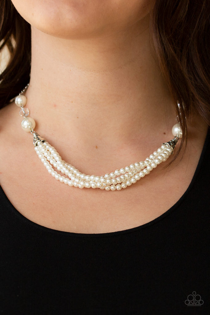 Oversized white pearls and crystal-like beads give way to layers of beaded pearl strands below the collar for a timeless look. Features an adjustable clasp closure.  Sold as one individual necklace. Includes one pair of matching earrings.