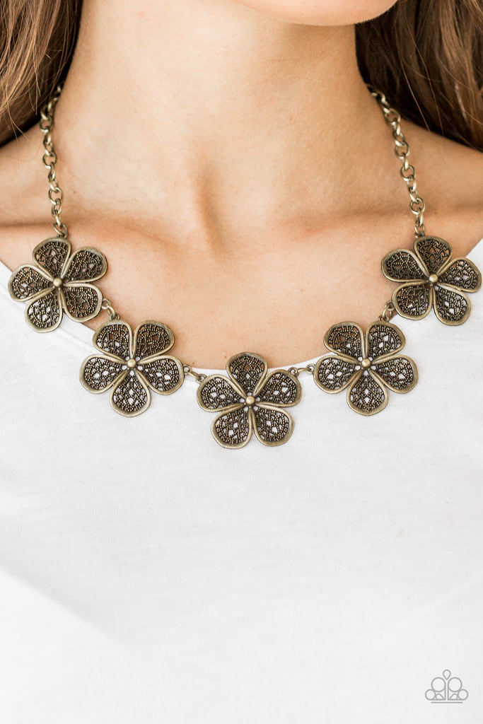 Featuring lace-like petals, glistening brass daisies link below the collar for a seasonal look. Features an adjustable clasp closure.  Sold as one individual necklace. Includes one pair of matching earrings.  