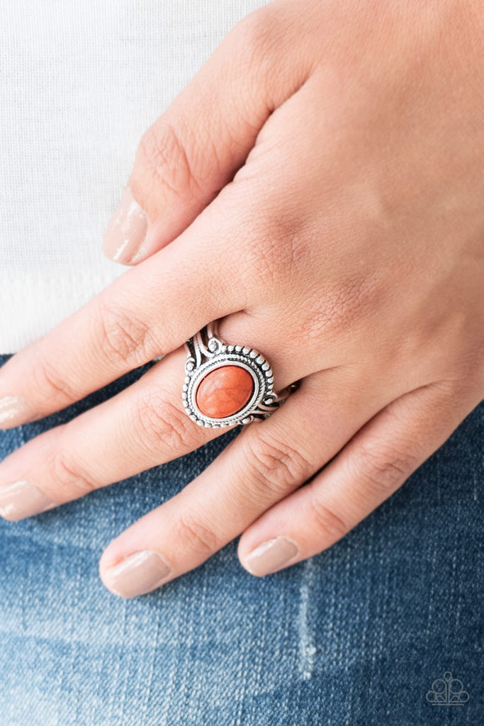 A vivacious orange stone is pressed into the center of a silver band radiating with silver studs for a seasonal look. Features a stretchy band for a flexible fit.  Sold as one individual ring.