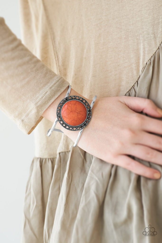 A vivacious orange stone is pressed into the center of a shimmery silver frame radiating with sunburst details. The earthy frame sits atop an airy silver cuff for a seasonal finish.  Sold as one individual bracelet.  