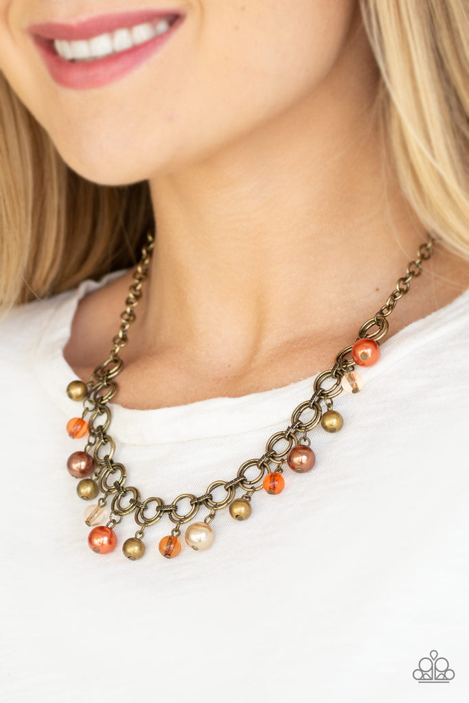 fiercely-fancy-multi Featuring pearly and glassy finishes, an array of brass, brown, and orange beads swing from a double-linked brass chain, creating a fancy fringe below the collar. Features an adjustable clasp closure.  Sold as one individual necklace. Includes one pair of matching earrings.