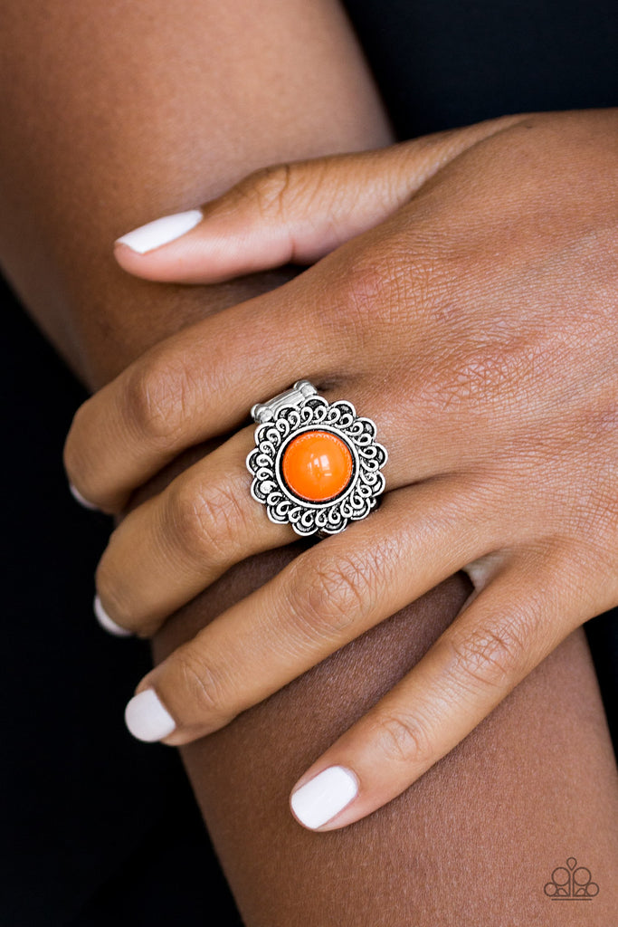 A vivacious orange bead is pressed into the center of a shimmery floral frame radiating with swirling detail. Features a stretchy band for a flexible fit.  Sold as one individual ring.  