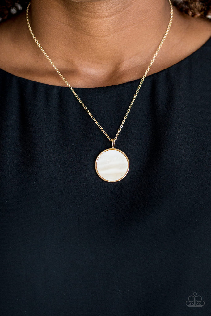 A flat shell-like pendant swings from the bottom of a dainty gold chain below the collar for a refined look. Features an adjustable clasp closure.  Sold as one individual necklace. Includes one pair of matching earrings.  