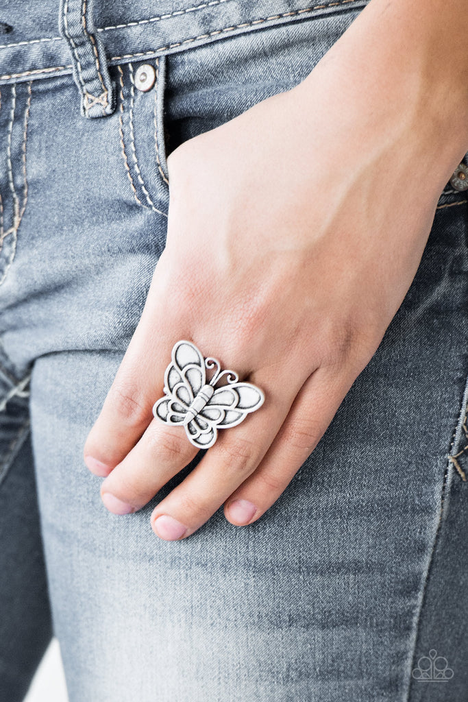 Brushed in an antiqued finish, a dramatic silver butterfly blooms across the finger for a whimsical look. Features a stretchy band for a flexible fit.  Sold as one individual ring.  