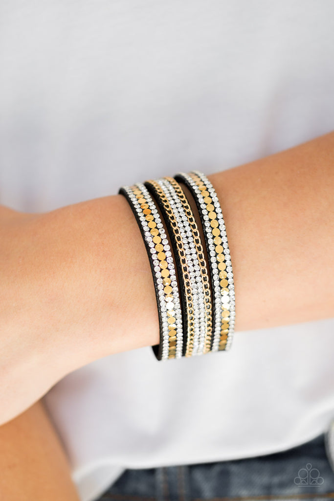 Rows of flat gold discs, glassy white rhinestones, and shimmery gold chains are encrusted along black suede bands for a sassy look. Features an adjustable snap closure.  Sold as one individual bracelet.