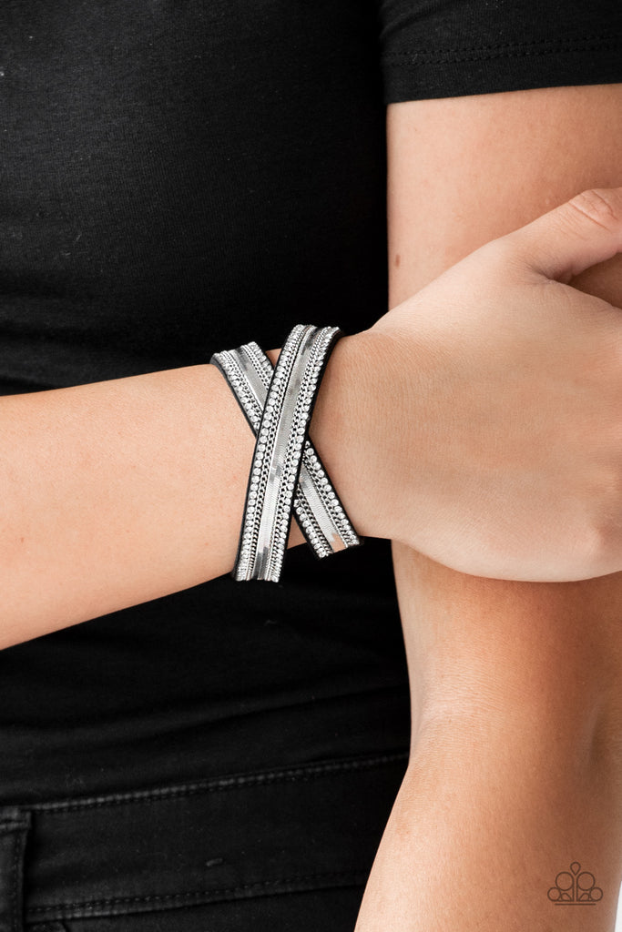 Rows of classic silver chain, flat silver chain, and dainty white rhinestones are encrusted along a black suede band for a sassy look. The elongated band allows for a trendy double wrap design. Features an adjustable snap closure.  Sold as one individual bracelet.