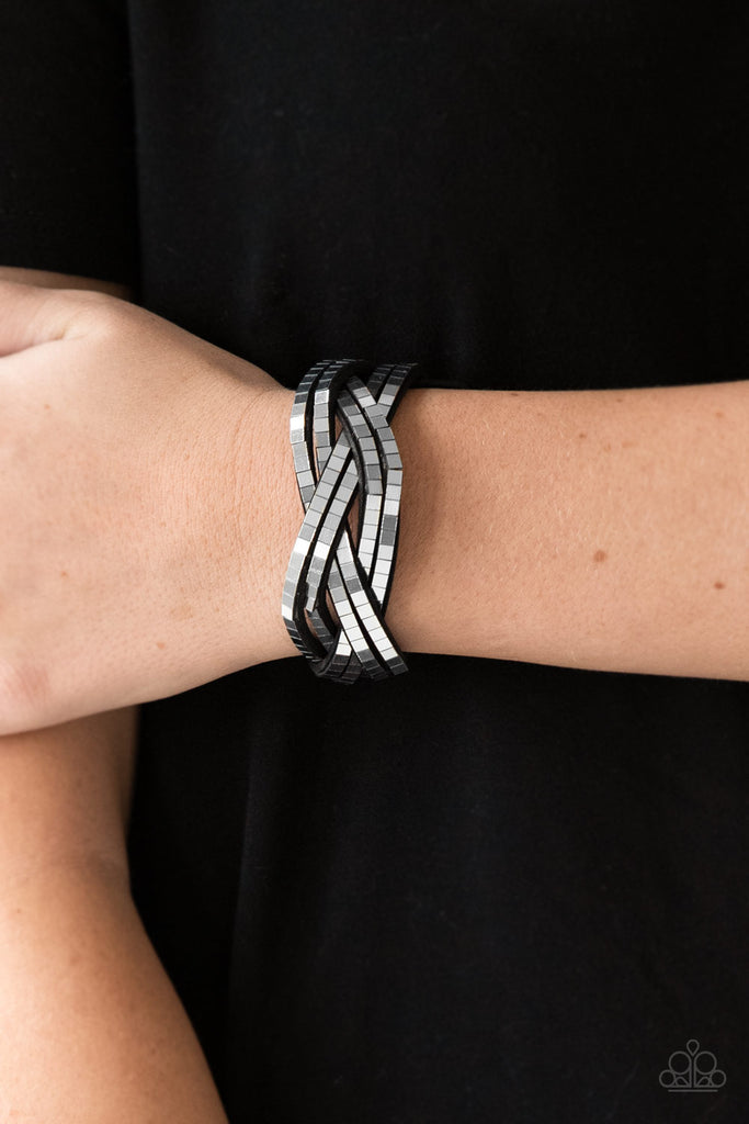 Flat silver cubes are encrusted along rows of braided gray suede for an edgy look. Features an adjustable snap closure.  Sold as one individual bracelet.  