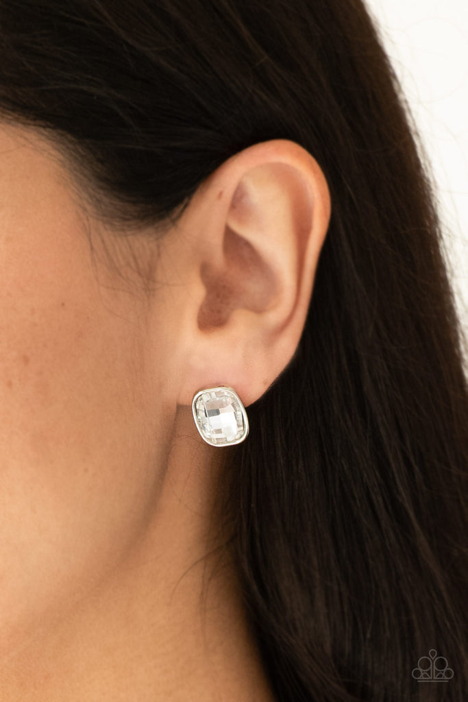 A faceted white gem is pressed into a sleek silver frame for a glamorous look. Earring attaches to a standard post fitting.  Sold as one pair of post earrings.