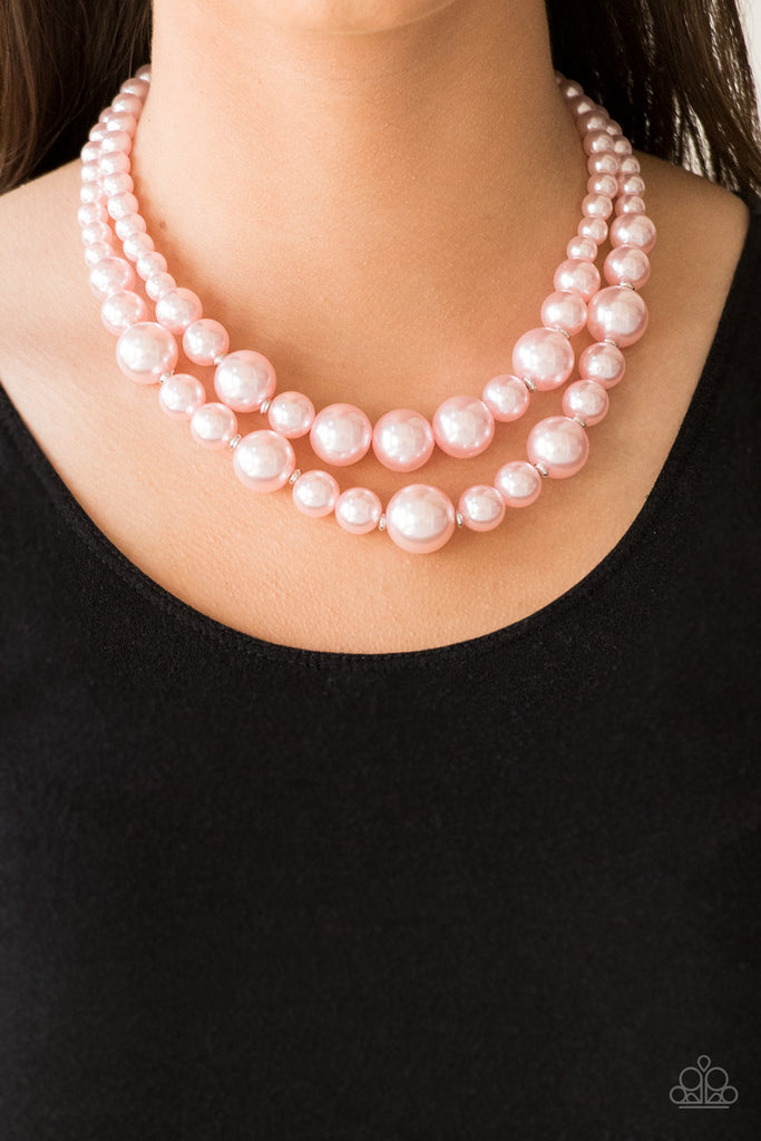 Infused with dainty silver accents, classic pink pearls layer below the collar in a timeless fashion. Features an adjustable clasp closure.  Sold as one individual necklace. Includes one pair of matching earrings.  