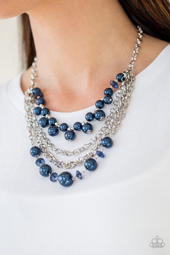 Varying in size, blue pearls, blue crystal-like beads, and faceted silver beads join with mismatched silver chains below the collar, creating a radically refined fringe. Features an adjustable clasp closure.  Sold as one individual necklace. Includes one pair of matching earrings.