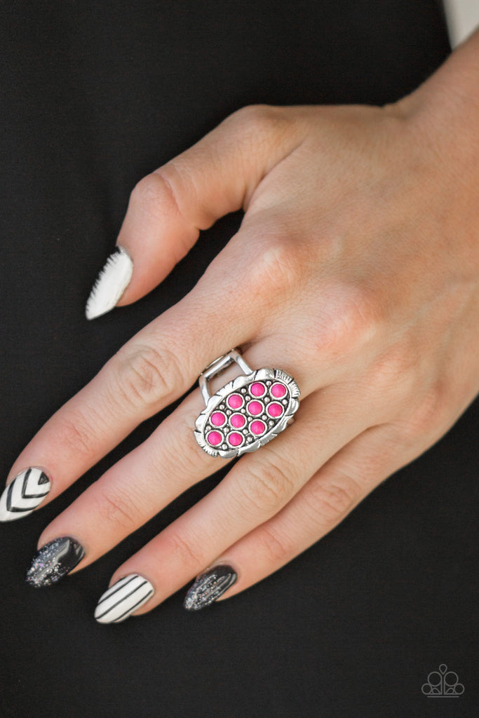 Dainty pink stones are sprinkled across the front of a studded silver frame, creating a vivacious centerpiece atop the finger. Features a stretchy band for a flexible fit.  Sold as one individual ring.