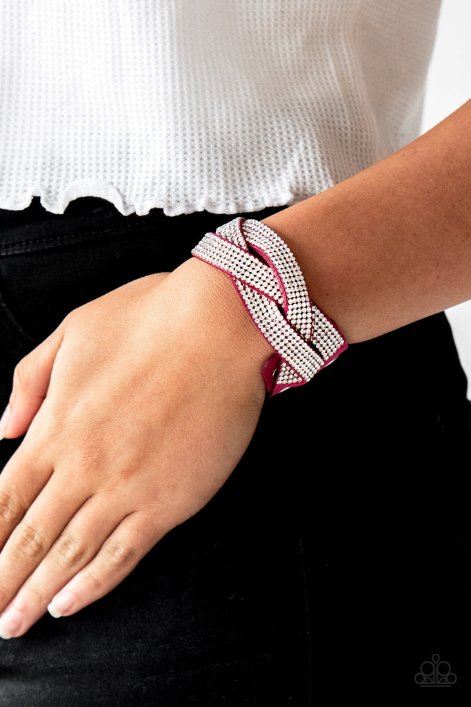 Encrusted in row after row of glittery white rhinestones, three pink suede bands braid across the wrist for a sassy look. Features an adjustable snap closure.  Sold as one individual bracelet.