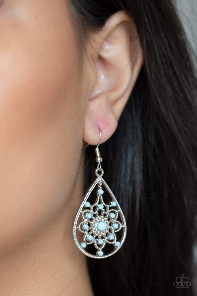 Dainty blue beads are sprinkled across the front of a shimmery silver teardrop frame radiating with floral patterned filigree for a whimsical look. Earring attaches to a standard fishhook fitting.  Sold as one pair of earrings.